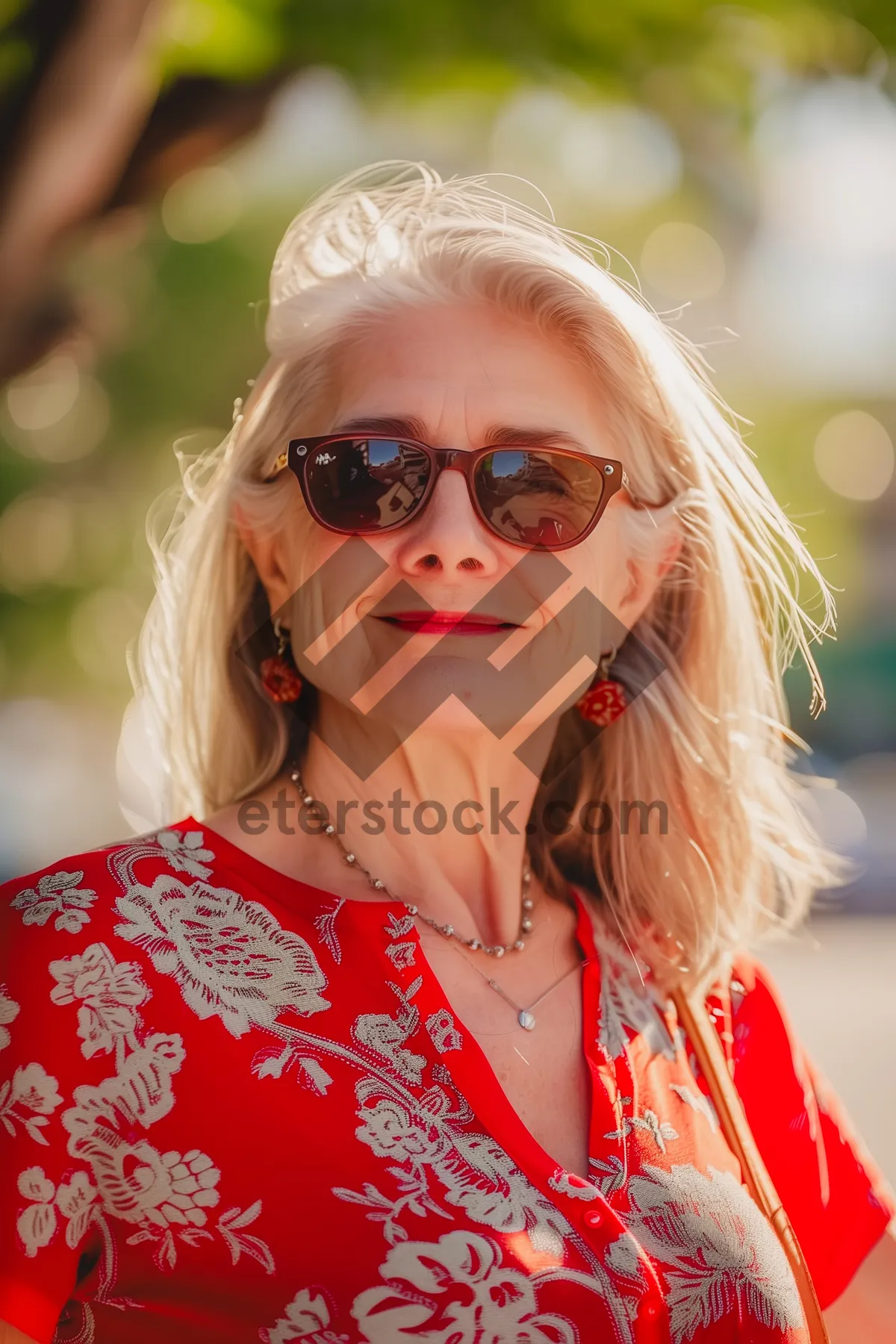 Picture of Blonde model in sunglasses with cute smile.