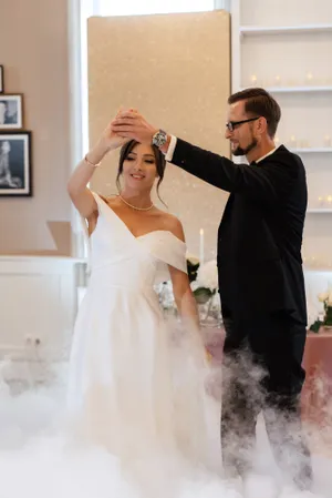 Happy couple celebrating wedding with flowers and smile