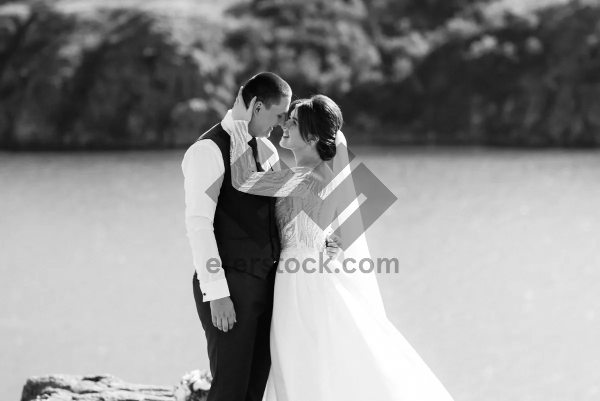 Picture of Happy newlywed couple celebrating love on wedding day outdoors.