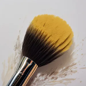 Colorful makeup brush applying vibrant paint