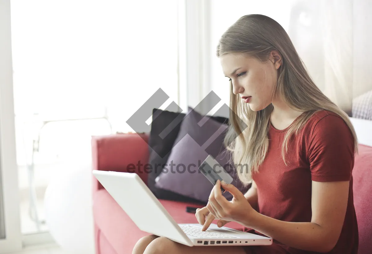 Picture of Happy businesswoman working on laptop at home office.