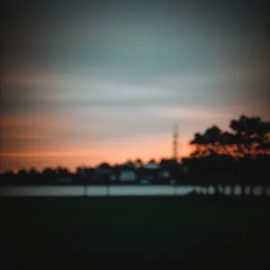 Vibrant Sunset Silhouette Over Summer Horizon