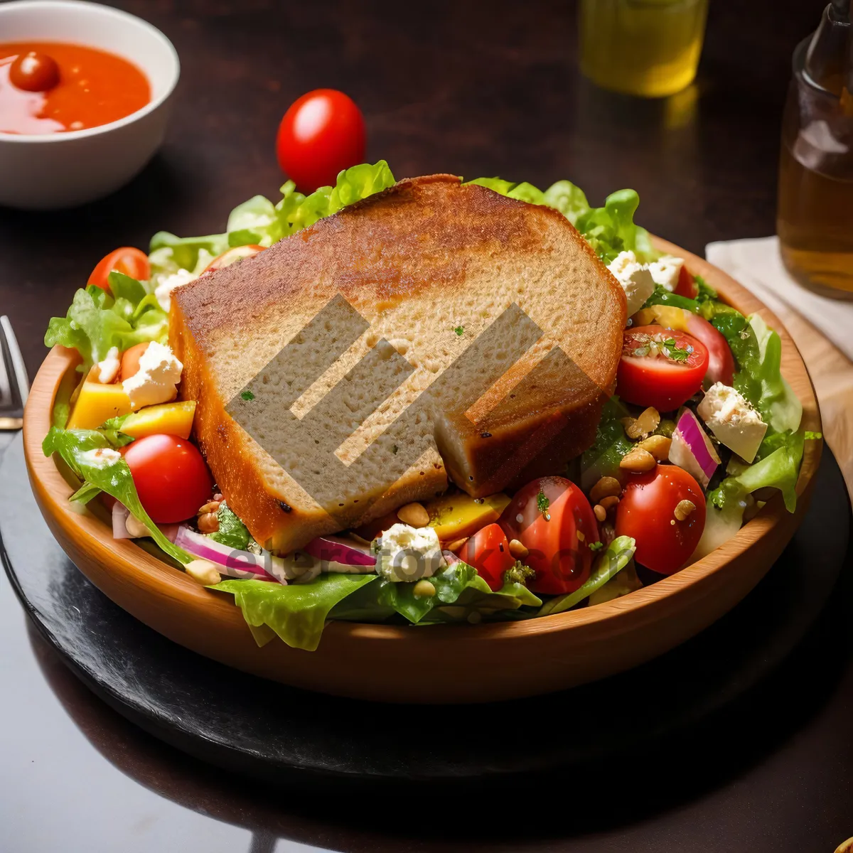 Picture of Delicious gourmet chicken dish with roasted vegetables and bread