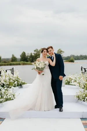 Happy wedding couple posing outdoors in love and happiness