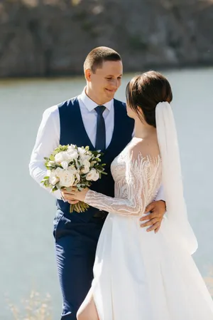 Happy Wedding Couple Outdoors Celebrating Love with Flowers