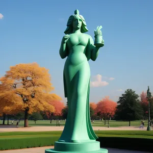 Skyward Reach: Majestic Statue on Pedestal in Park