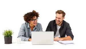 Happy businessman working on laptop in modern office.