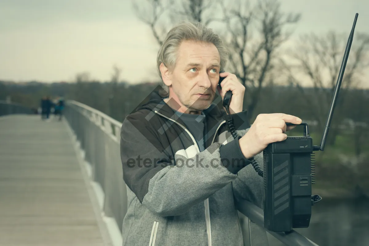 Picture of Happy male executive with laptop outdoors