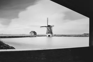 Cityscape with River and Wind Turbine