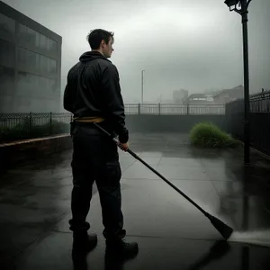 Male Cleaner with Hockey Stick Swabbing