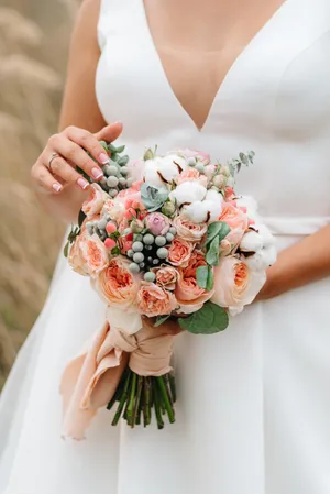 Happy newlywed couple with flower bouquet at wedding