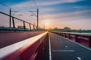 Urban Skyline with Highway and Bridge at Sunset