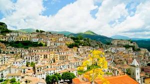 Cityscape with iconic palace and stunning mountain backdrop.