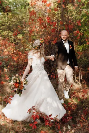 Wedding couple happily celebrating with bouquet of flowers