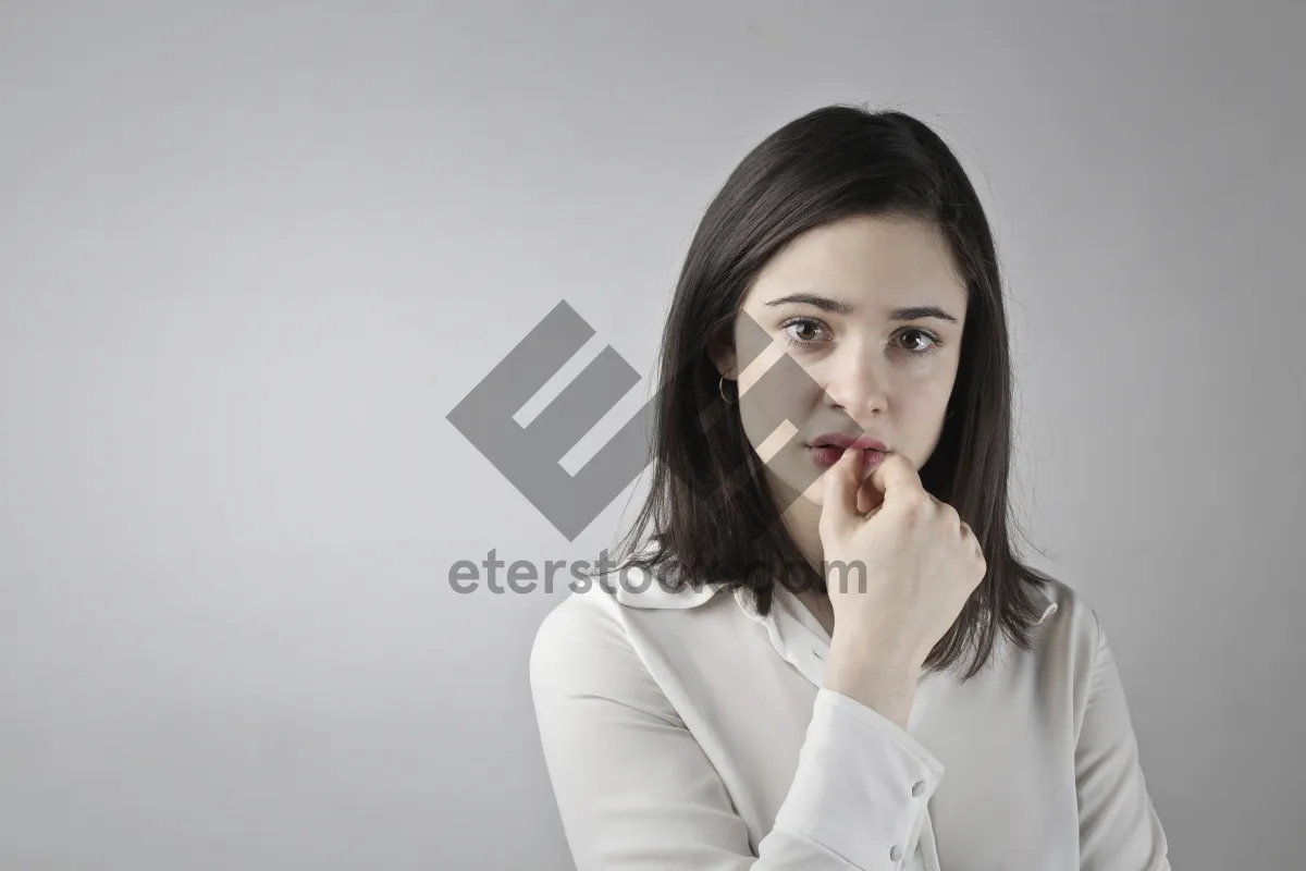 Picture of Attractive businesswoman in coat smiling professionally at office