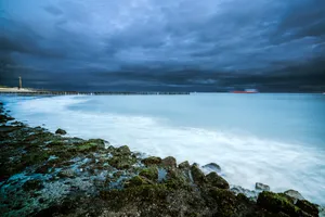 Sunset over rocky beach and wave