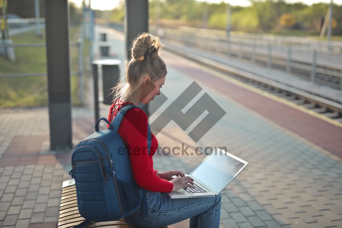 Picture of Happy businessman working on laptop in office.