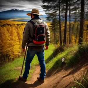 Outdoor Adventurer With Cowboy Hat and Backpack Hiking Mountains