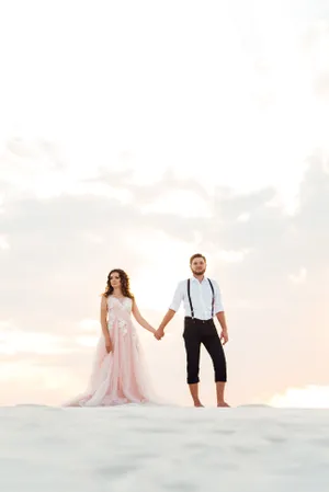 Happy newlywed couple on beach, smiling and in love.