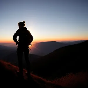 Sunset Mountain Hiker: Adventurous Silhouette in Majestic Landscape
