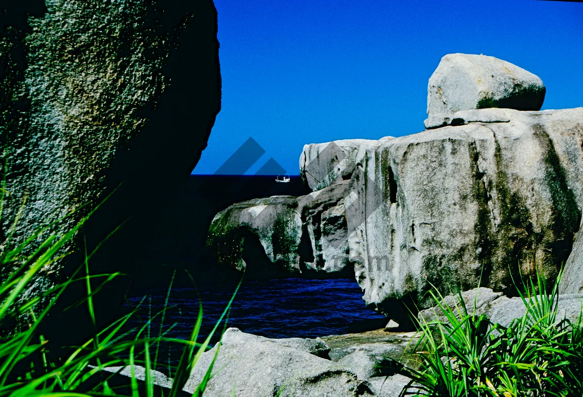 Picture of Ancient stone castle against mountain landscape backdrop