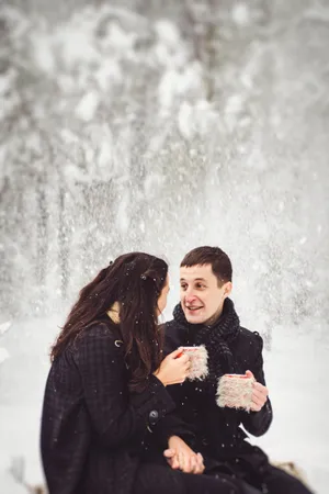 Smiling woman in winter park with snow