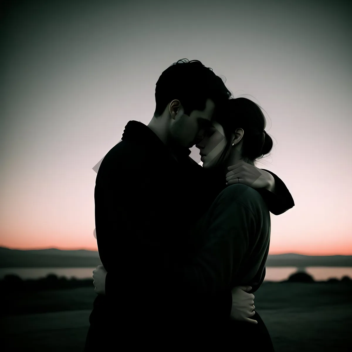 Picture of Happy Newlywed Couple Embracing in Sunset Silhouette