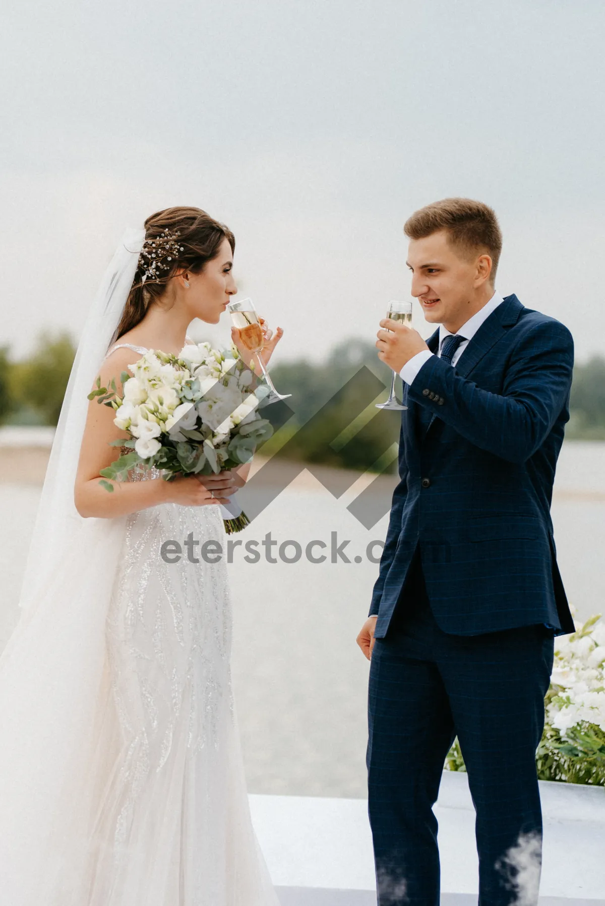 Picture of Happy couple celebrating their marriage with flower bouquet.