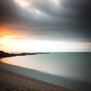Vibrant Orange Sunset Over Ocean Waves