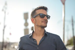 Stylish businessman in sunglasses smiling confidently