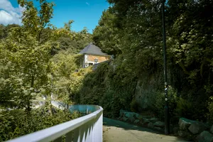 Wooden house with picket fence in forest landscape