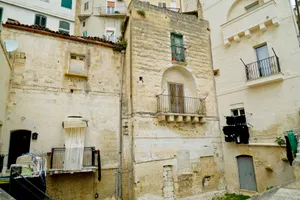 Historic stone building with balcony in old city center.