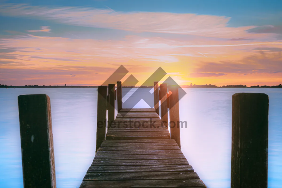 Picture of Tropical sunset over beach with boat dock.