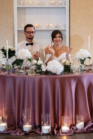 Happy wedding couple smiling together outdoors with flowers