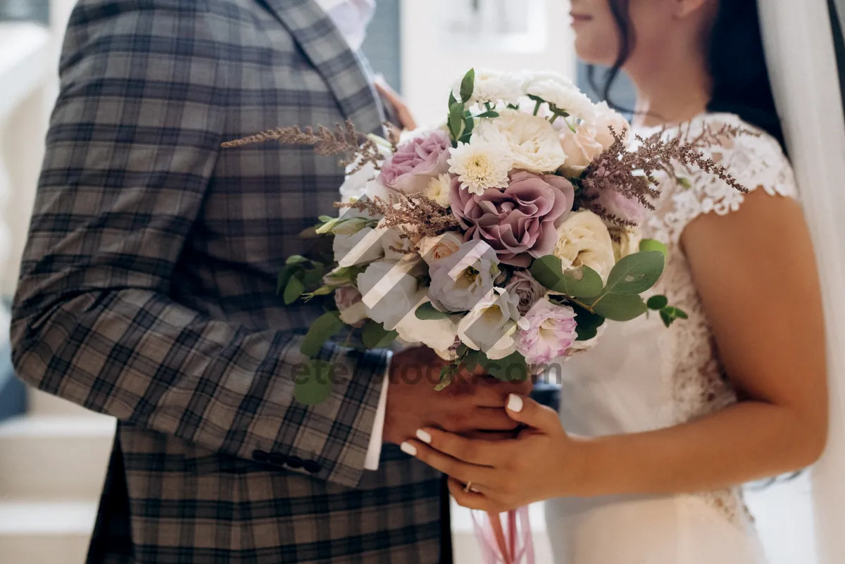 Picture of Happy Bride and Groom with Floral Bouquet