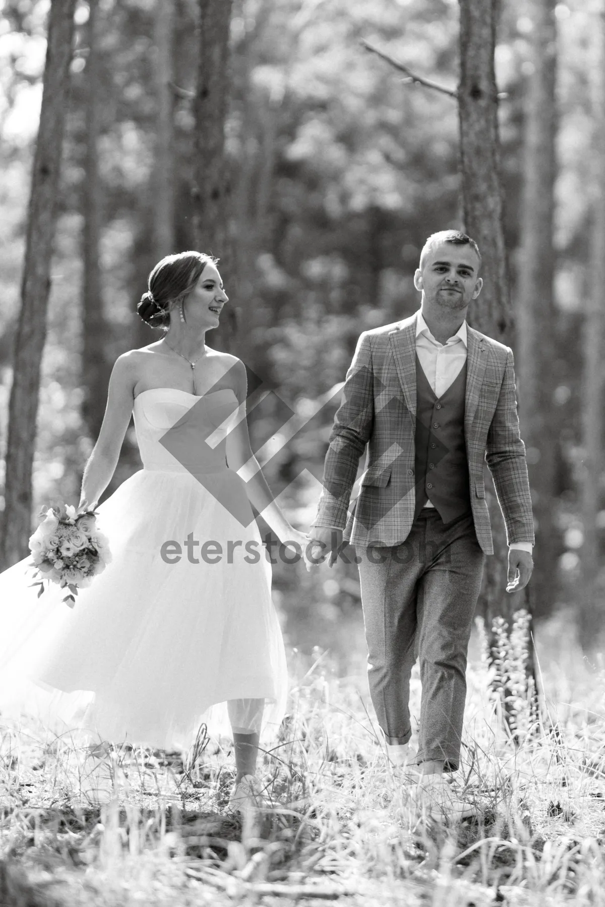 Picture of Happy couple celebrating wedding in the park.