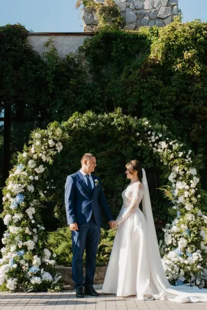 Happy bride and groom celebrating outdoors in park.