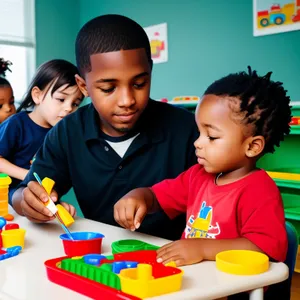 Cheerful schoolboy happily sitting in classroom