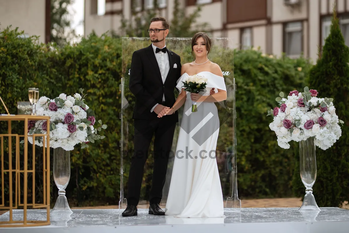 Picture of Smiling groom and bride celebrating love outdoors