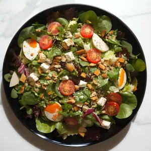 Vegetarian Chickpea Salad with Olive and Tomato Slices.