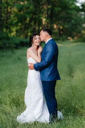 Happy couple in park on wedding day