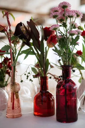 Glass jar with beautiful flower bouquet centerpiece