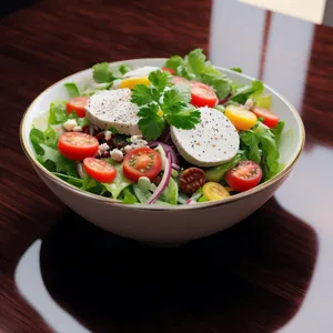 Fresh vegetable salad with cherry tomatoes and cheese slice.