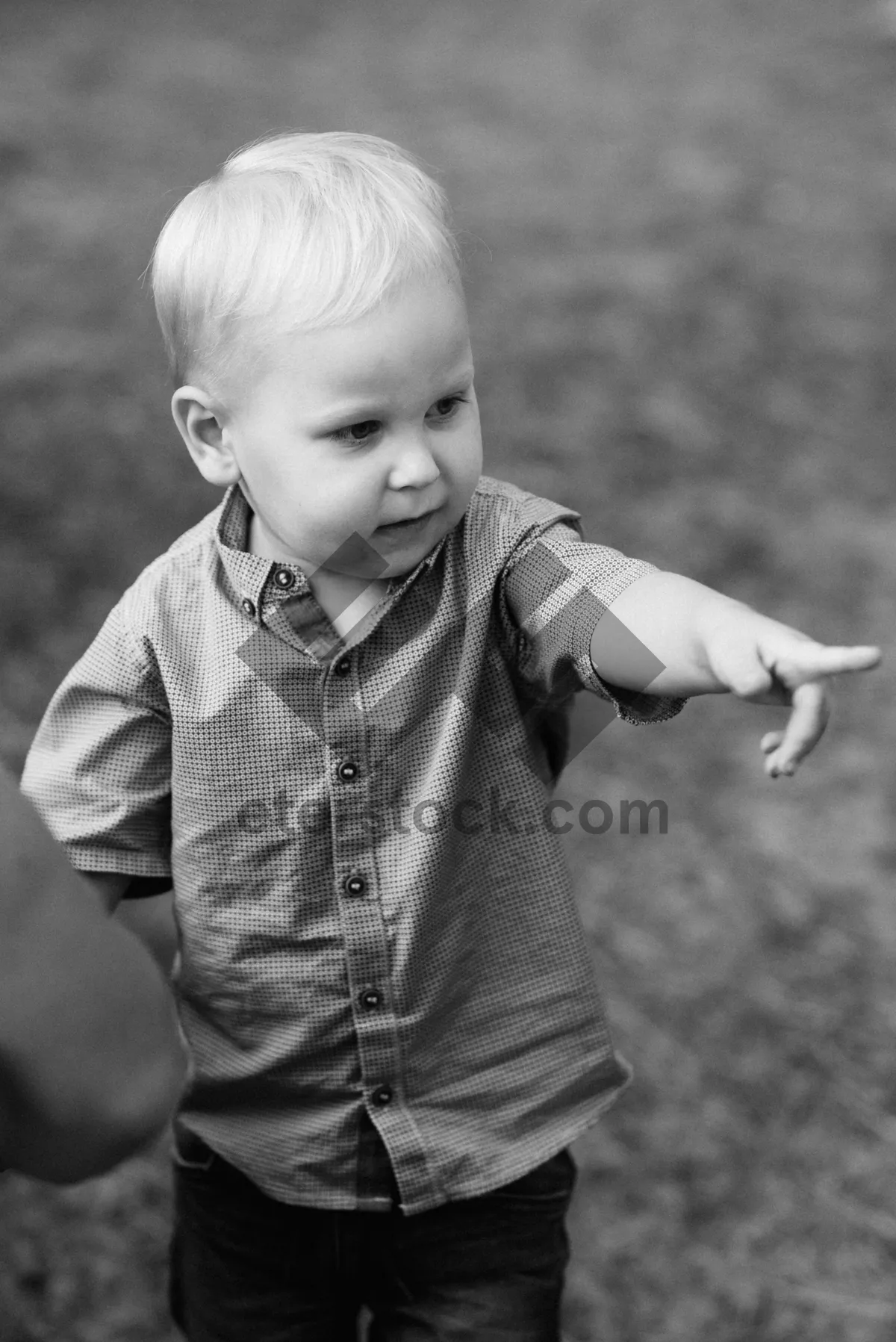 Picture of Happy blonde boy smiling in the park.