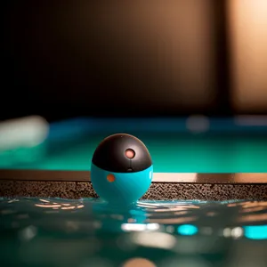 Portable computer on pool table with glowing background.