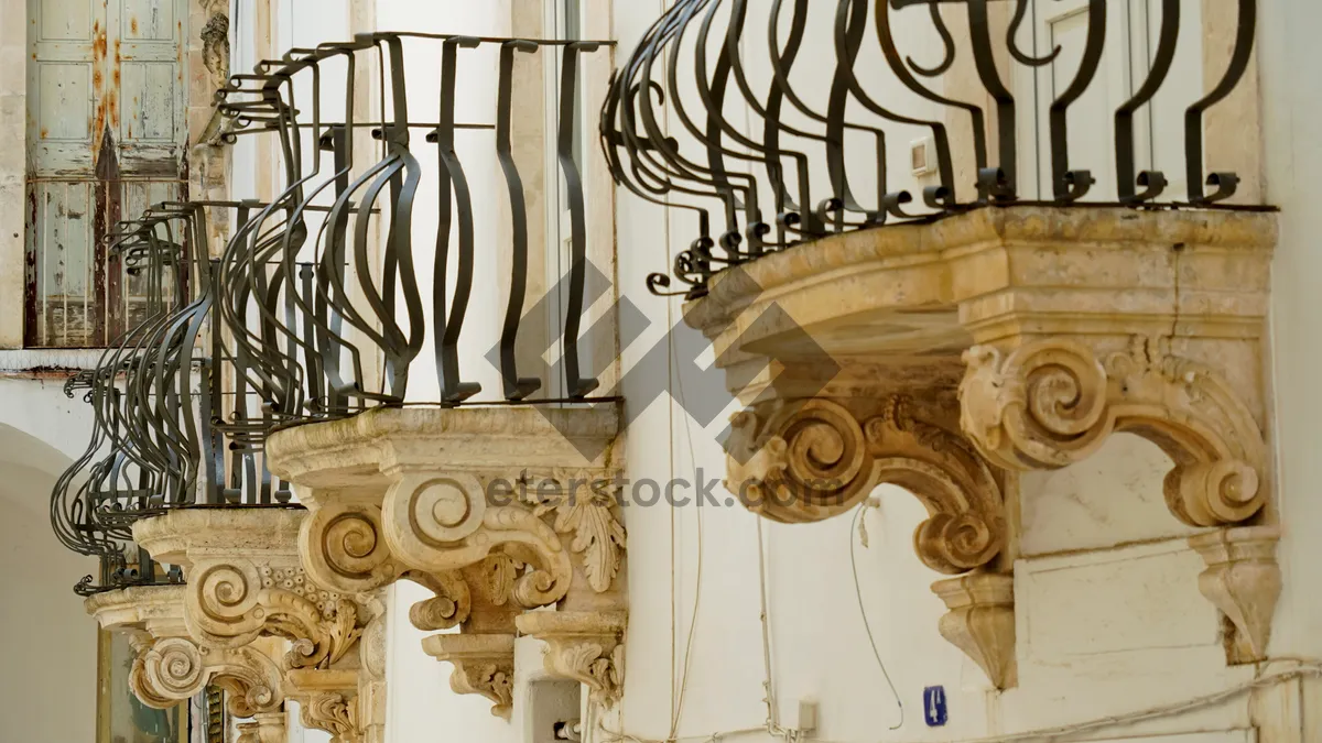 Picture of Old stone balcony sculpture at historical landmark facade