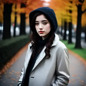 Attractive brunette woman outdoors smiling in coat.