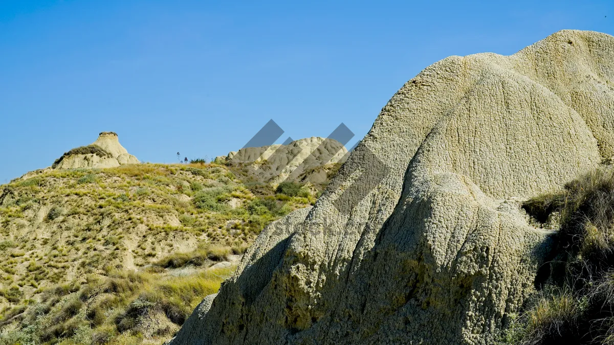 Picture of Mountain Range Scenery with Stone Megalith in Rural Landscape