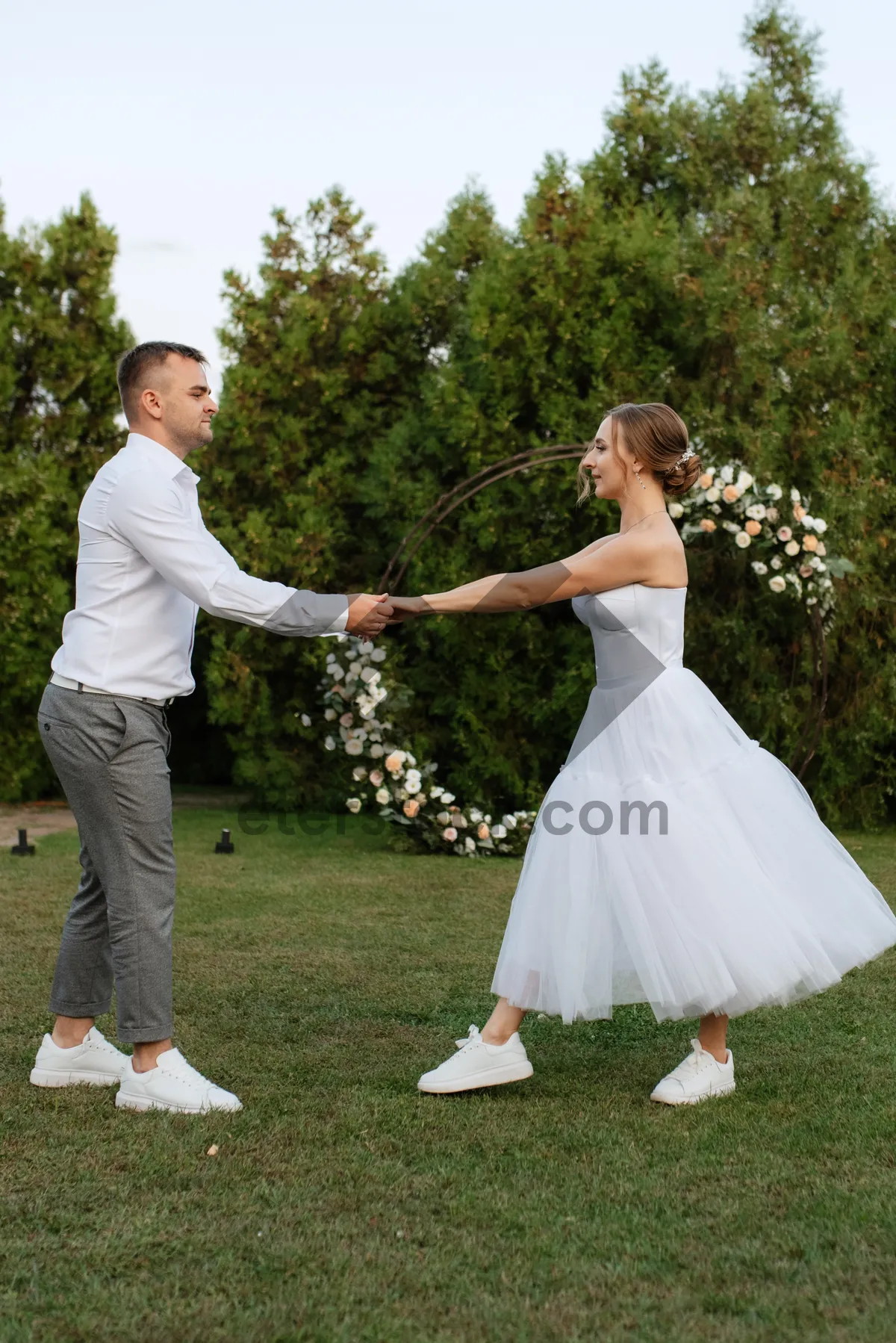 Picture of Happy Couple in Wedding Attire Smiling Outdoors