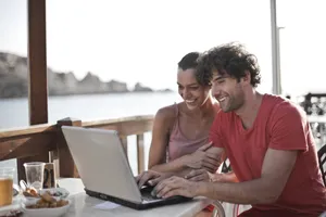 Happy man working on laptop at home office